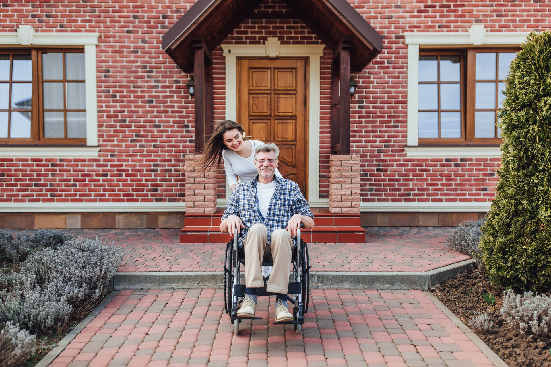 enjoying-family-time-elderly-man-wheelchair-smiling-daughter-garden